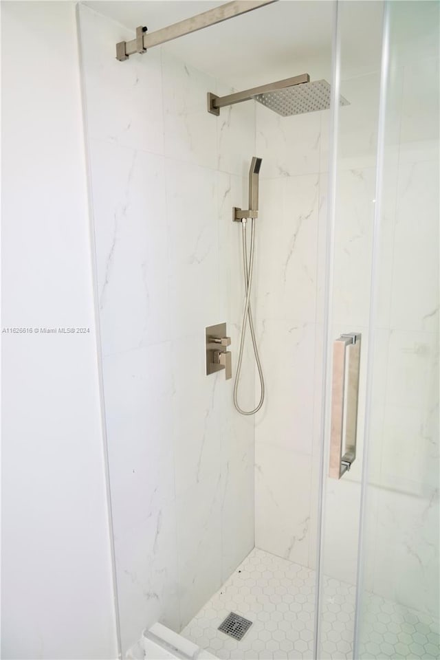 bathroom featuring a shower with shower door