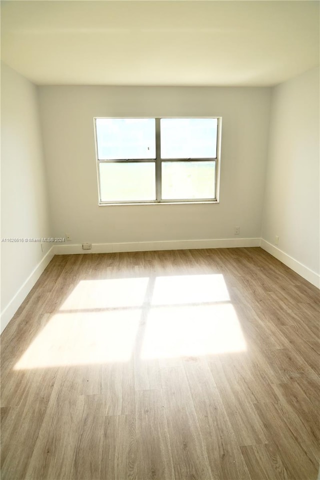 unfurnished room featuring light hardwood / wood-style floors