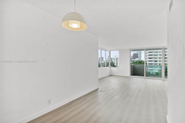 1200 W Ave Unit 515, Miami Beach, FL 33139 - spare room with baseboards, a view of city, and wood finished floors
