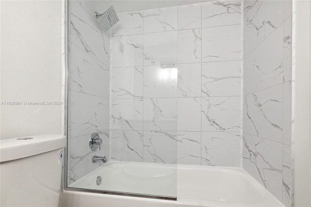 bathroom featuring shower / bath combination with glass door and toilet