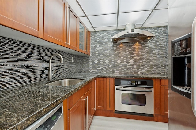 kitchen featuring decorative backsplash, sink, dark stone countertops, dishwasher, and custom range hood