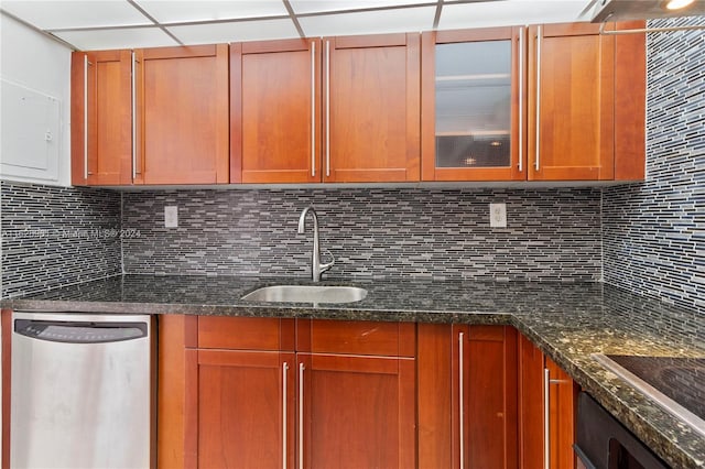 kitchen featuring dark stone counters, tasteful backsplash, sink, electric stovetop, and dishwasher