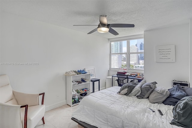 bedroom featuring a textured ceiling and ceiling fan