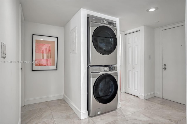 laundry room with stacked washing maching and dryer