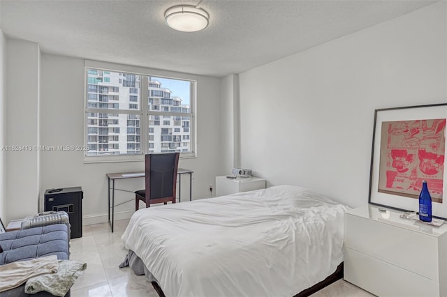 tiled bedroom featuring a textured ceiling