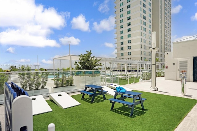 view of home's community with a yard and a pergola