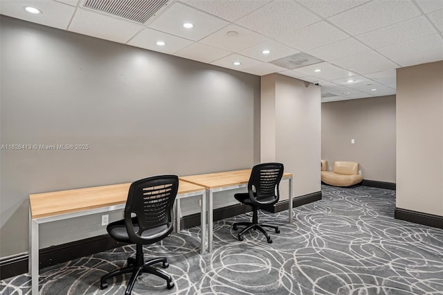 office space with a paneled ceiling