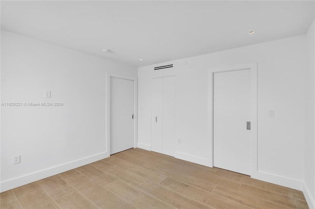 spare room featuring light hardwood / wood-style flooring