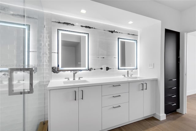 bathroom featuring hardwood / wood-style floors and dual bowl vanity