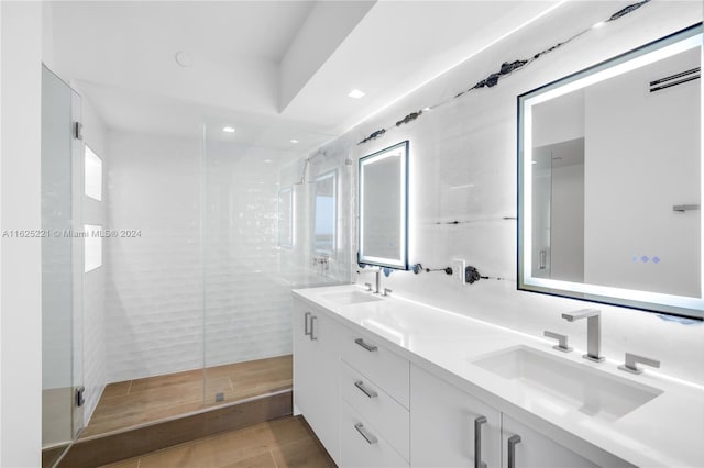 bathroom featuring double vanity, tile patterned flooring, and a shower with shower door