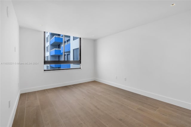 spare room with light hardwood / wood-style flooring