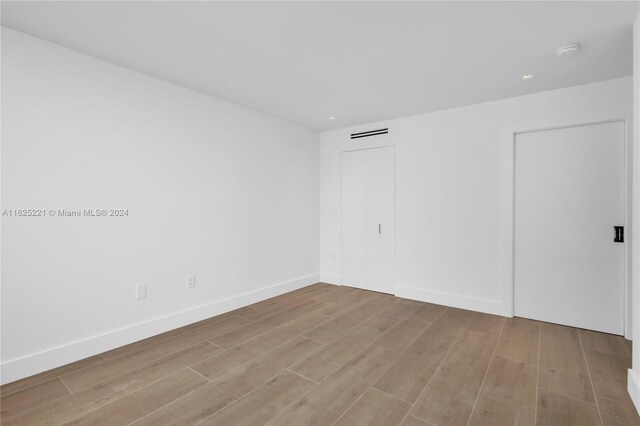 spare room with hardwood / wood-style flooring