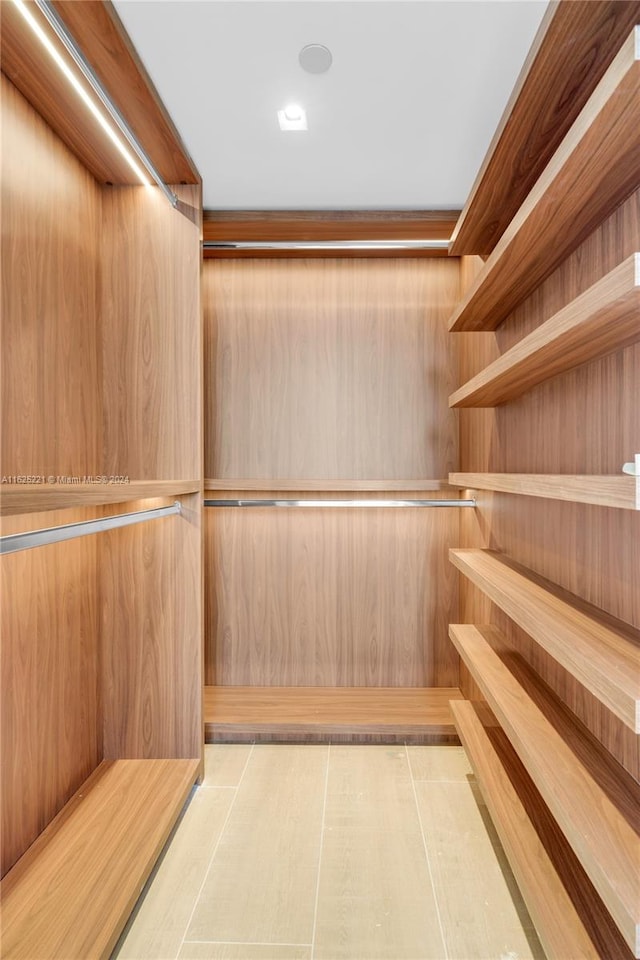 spacious closet featuring light tile patterned floors