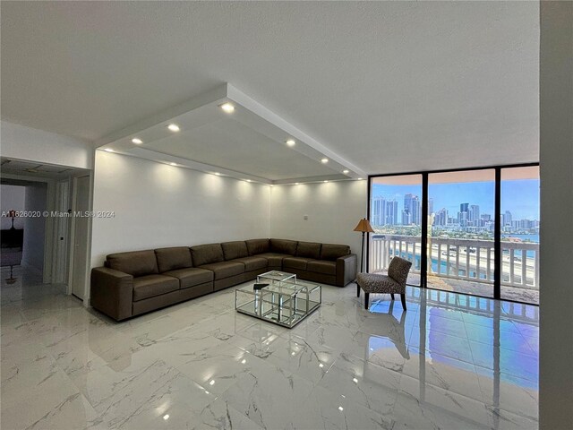 living room featuring expansive windows and light tile patterned floors