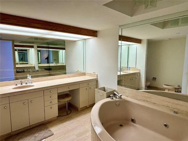 bathroom with beamed ceiling, vanity, toilet, and a bathtub