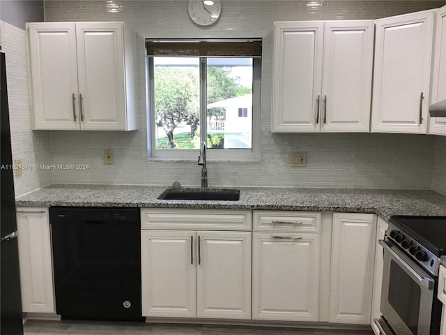 kitchen with sink, light stone counters, white cabinetry, and dishwasher