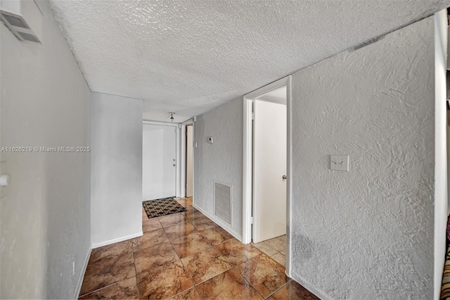 corridor featuring a textured ceiling