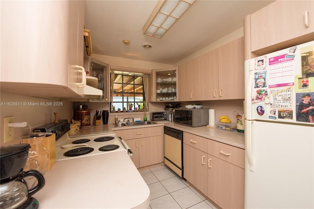 kitchen featuring light tile patterned flooring, sink, light brown cabinetry, and white appliances