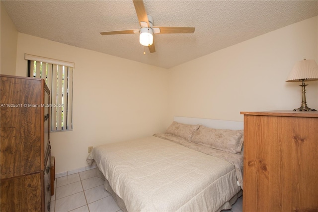 tiled bedroom featuring a textured ceiling and ceiling fan