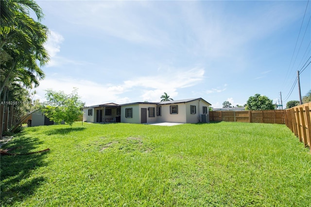 back of house with a lawn