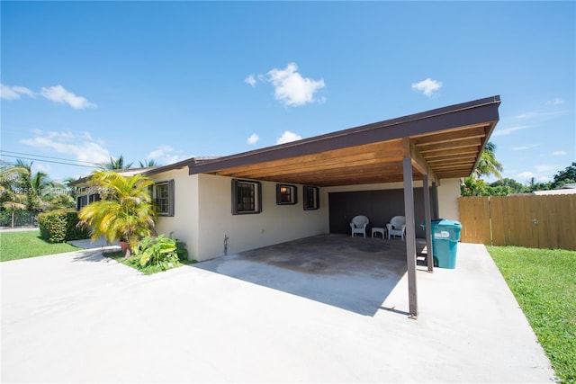 view of side of home with a carport