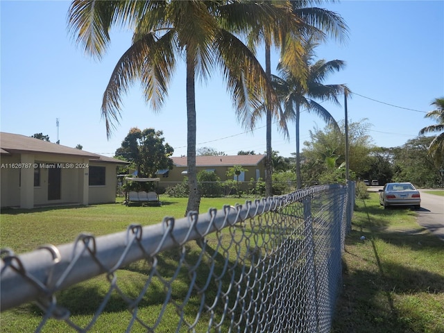 view of gate with a lawn