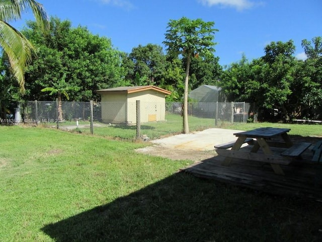 view of yard with a storage unit and a patio