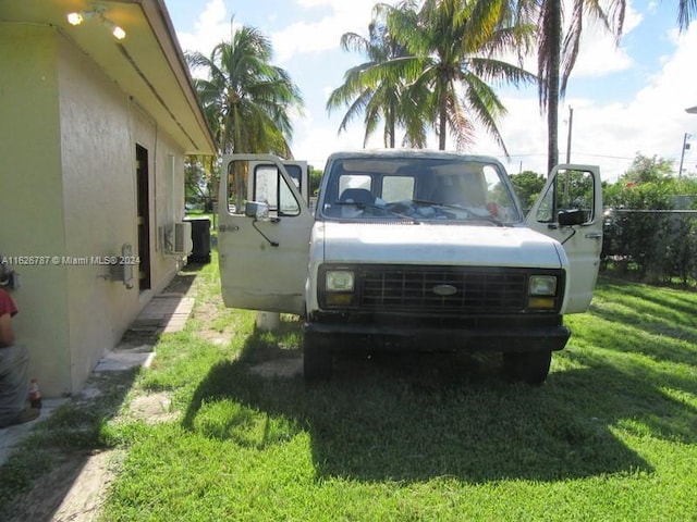 view of vehicle parking featuring a yard