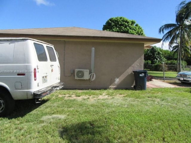 view of property exterior featuring ac unit and a yard