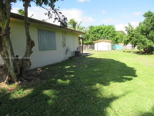 view of yard with a storage shed and central AC unit