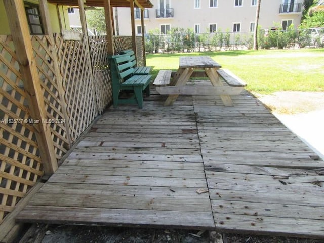 wooden terrace featuring a yard