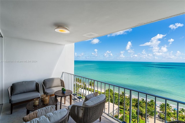 balcony with an outdoor living space and a water view