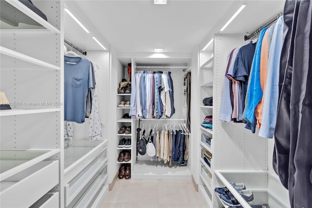 walk in closet with light tile patterned flooring