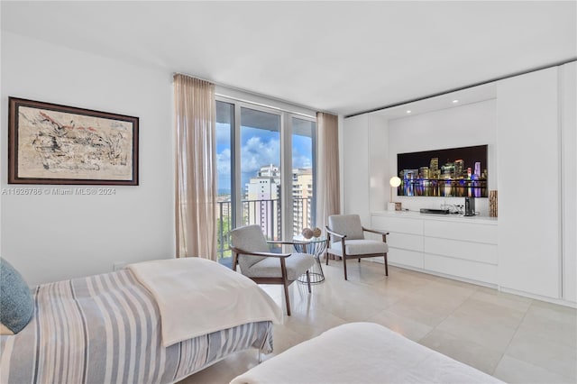 bedroom featuring expansive windows and access to exterior