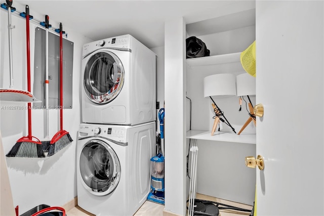 washroom with stacked washing maching and dryer