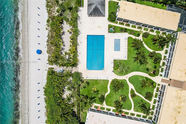 birds eye view of property with a water view and a view of the beach