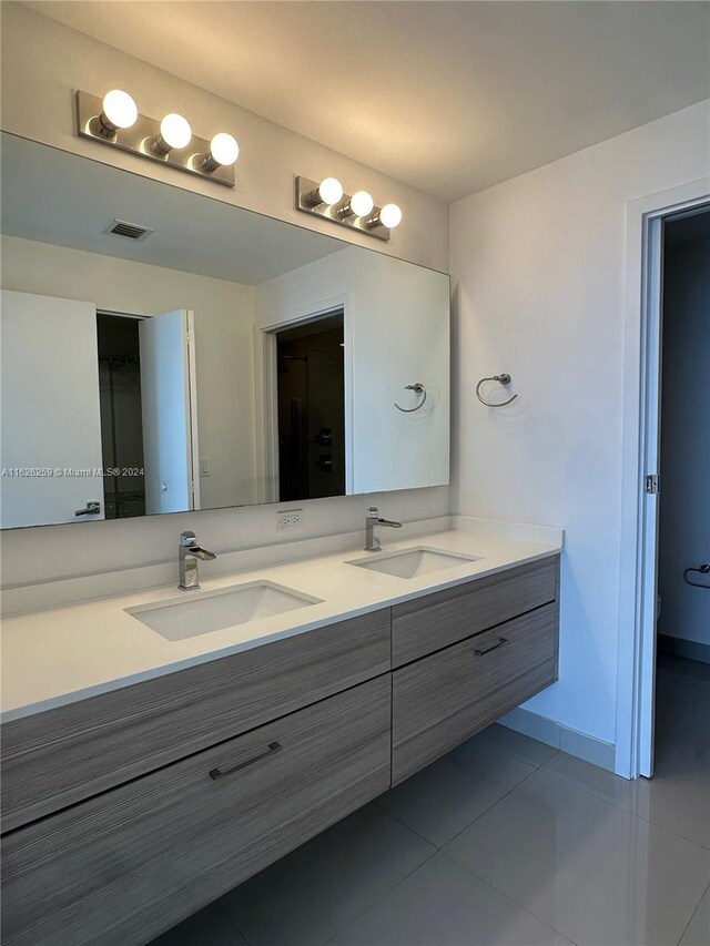 bathroom with tile patterned floors, vanity, and toilet