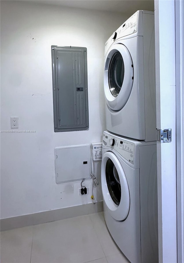 600 NE 27th St Unit 2302, Miami, FL 33137 - washroom featuring tile patterned floors, electric panel, and stacked washer / dryer