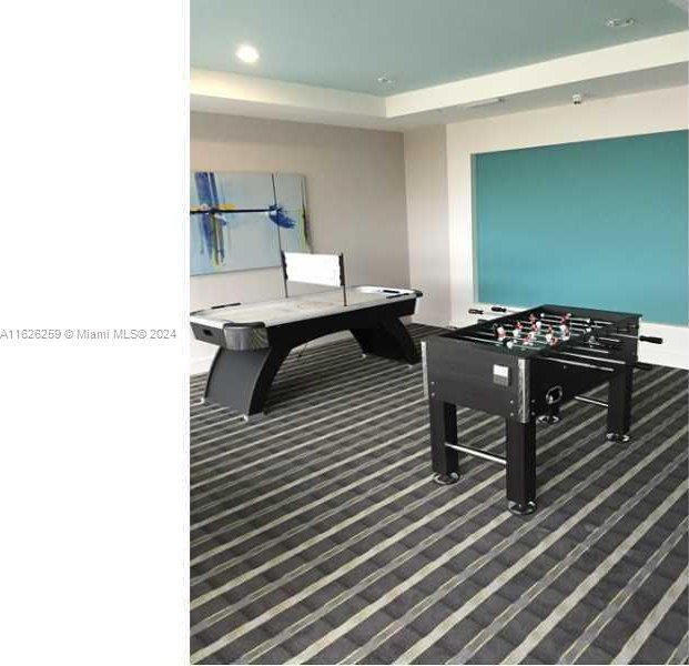 recreation room featuring carpet flooring