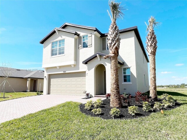 view of front of property with a garage and a front lawn