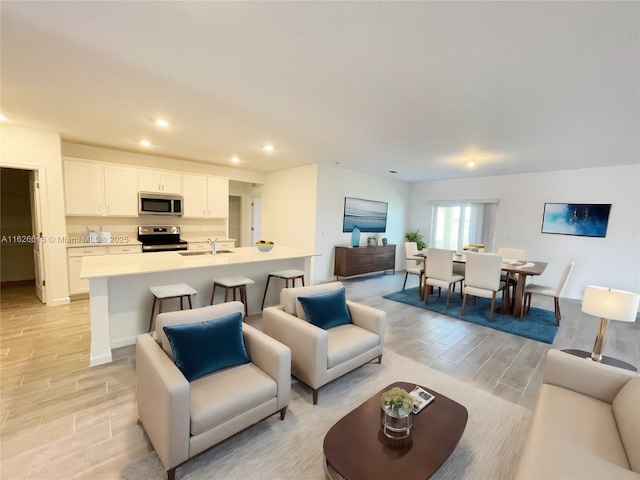 living area with wood tiled floor and recessed lighting