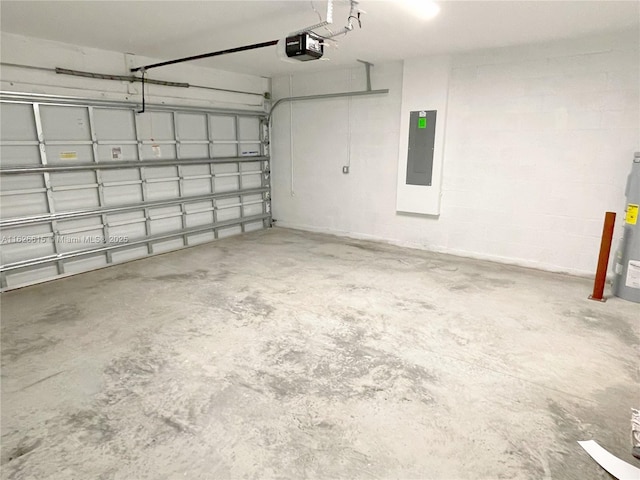 garage featuring water heater, electric panel, and a garage door opener