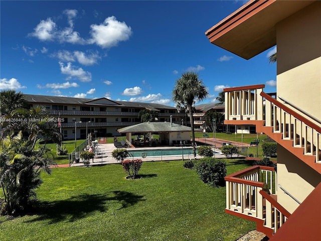 view of pool featuring a yard