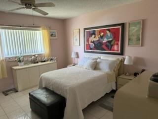 bedroom featuring light tile patterned floors and ceiling fan