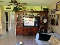 tiled living room featuring ceiling fan