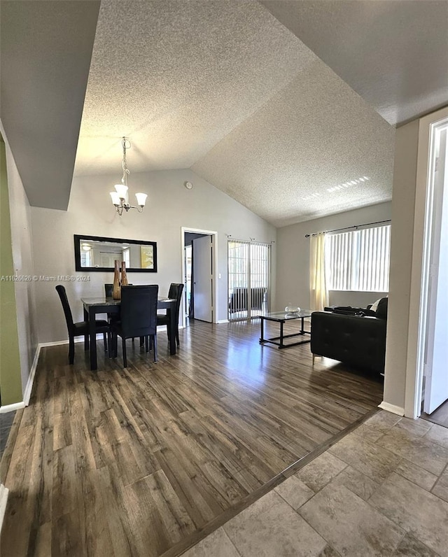 dining room with an inviting chandelier, hardwood / wood-style floors, vaulted ceiling, and a textured ceiling