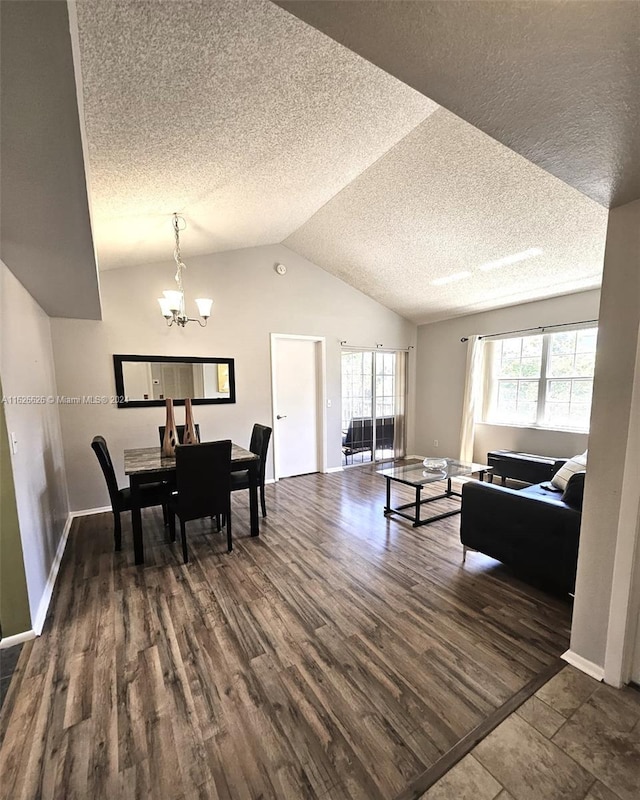 dining space with a notable chandelier, lofted ceiling, dark hardwood / wood-style floors, and plenty of natural light