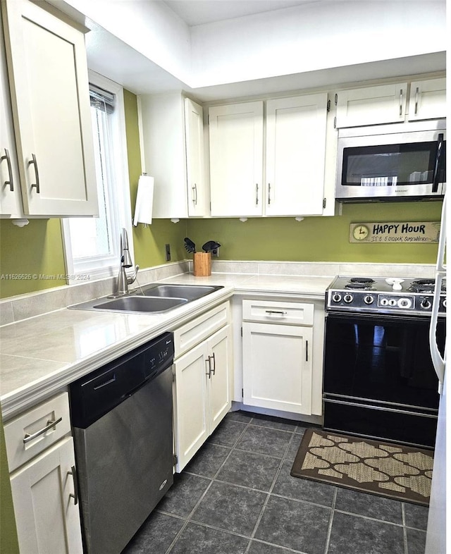 kitchen with white cabinetry, stainless steel appliances, and sink