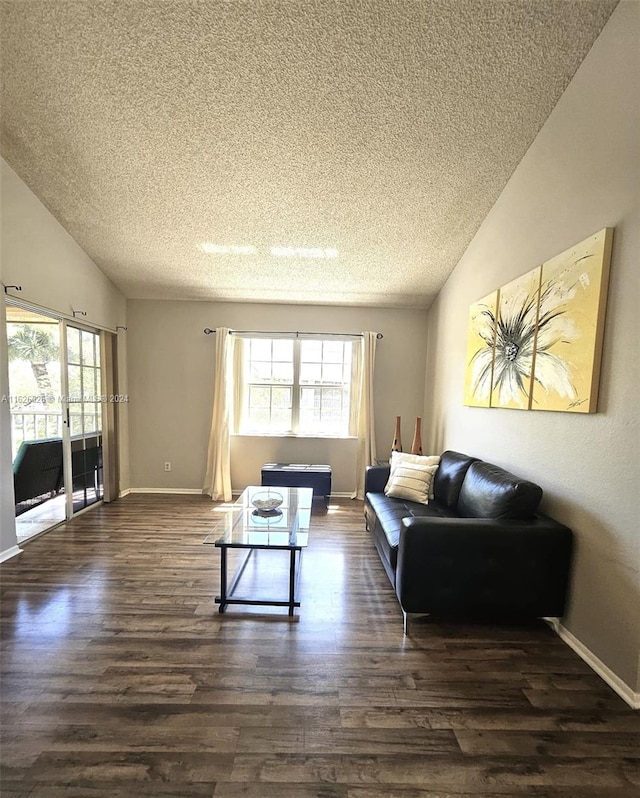 living room featuring a textured ceiling, lofted ceiling, and hardwood / wood-style floors