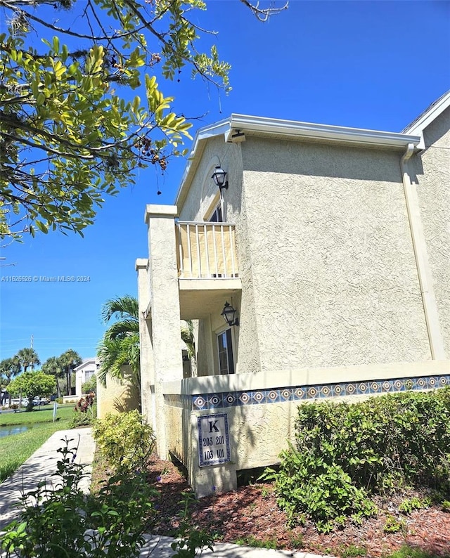 view of side of property with a balcony